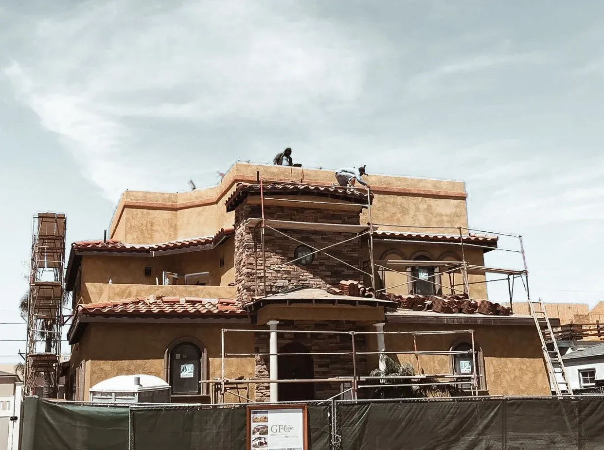 Chavez Roofing crew re-roofing a three-story home